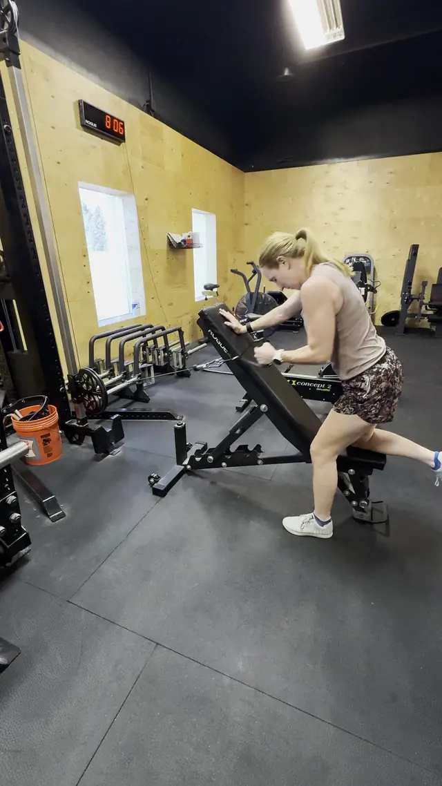 A barbell and weight plates in a gym
